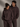 Two people wearing matching  Coco brown hoodies with a logo on a gray background