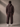 Person wearing a Coco brown tracksuit against a plain background
