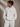 Person wearing a gray hoodie with 'LUXE' branding against a beige background